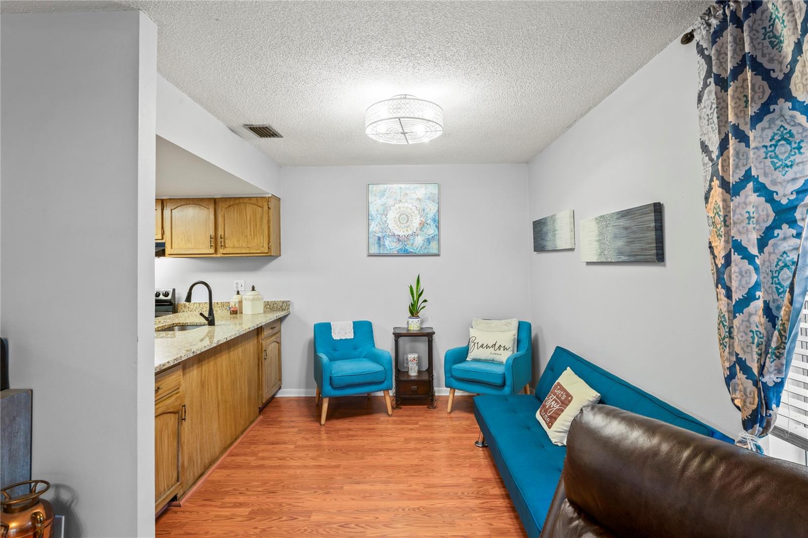 Dining area currently staged as a den or extra living room space