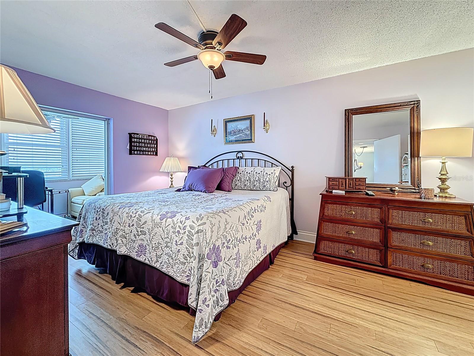 The primary bedroom welcomes you to relax and overlooks the florida room