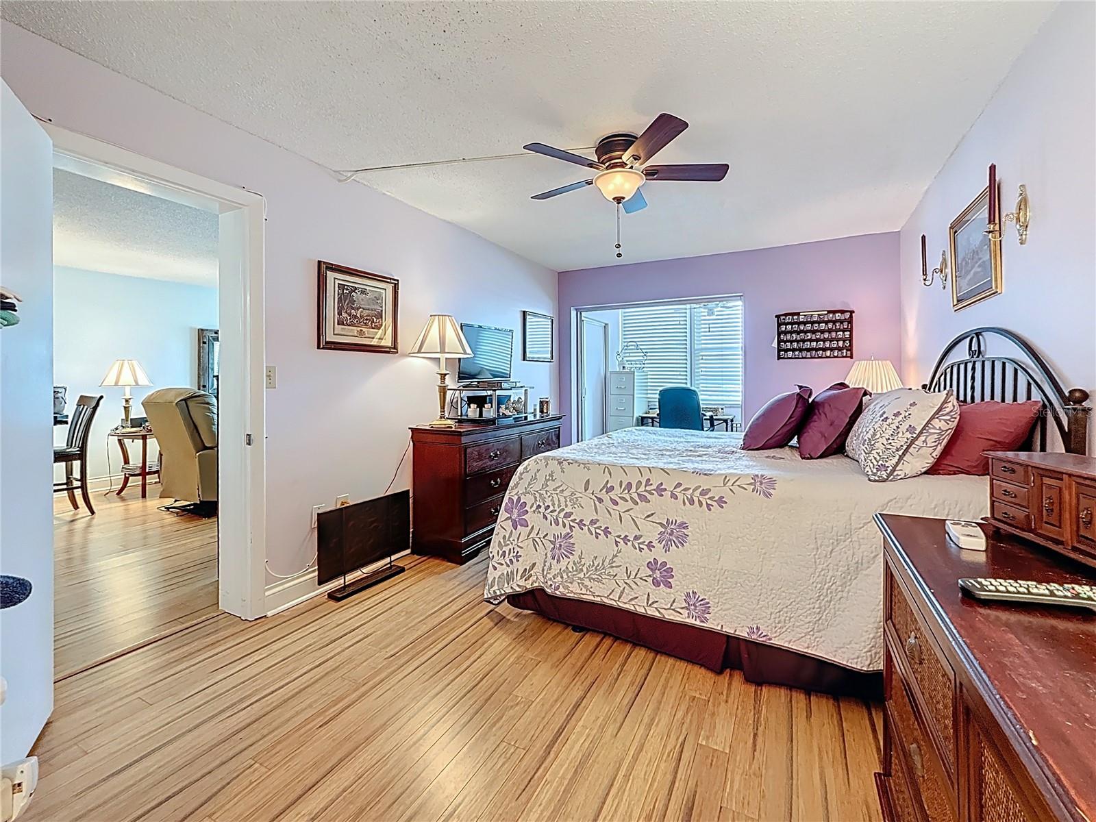 This is the spacious bedroom with bamboo flooring.