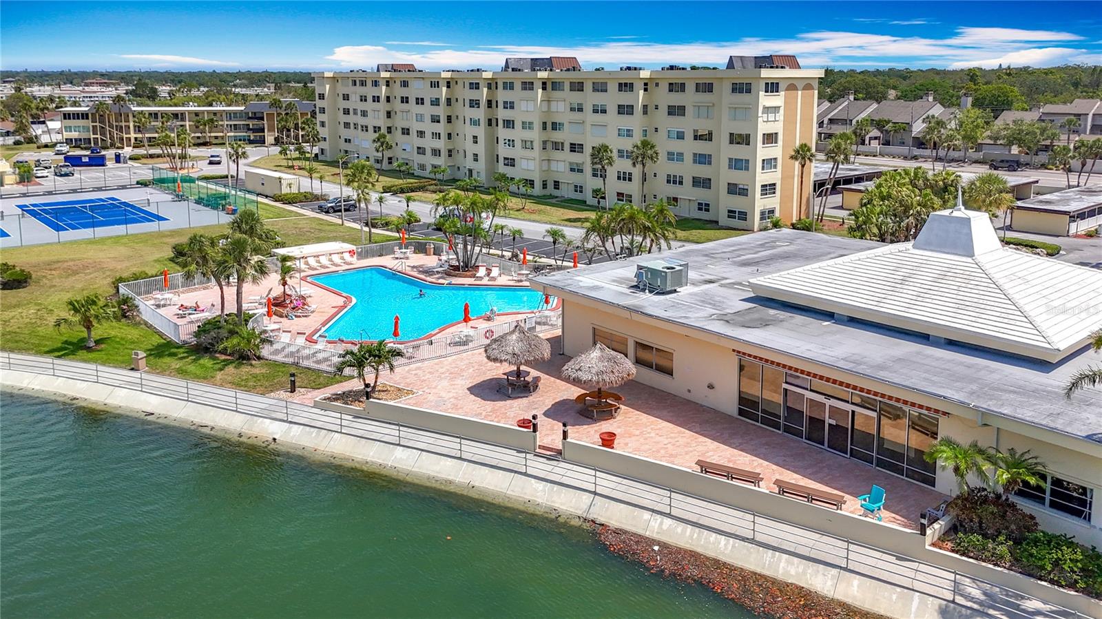 This aerial shows the pool by the clubhouse and the back of the clubhouse