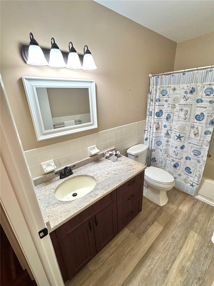 Updated guest bathroom with luxury vinyl plank flooring