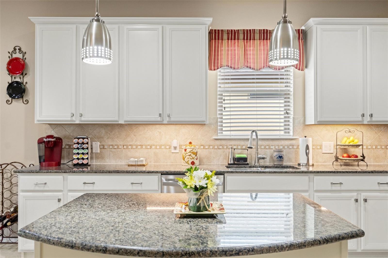 The granite topped Island has electric outlets at each end.