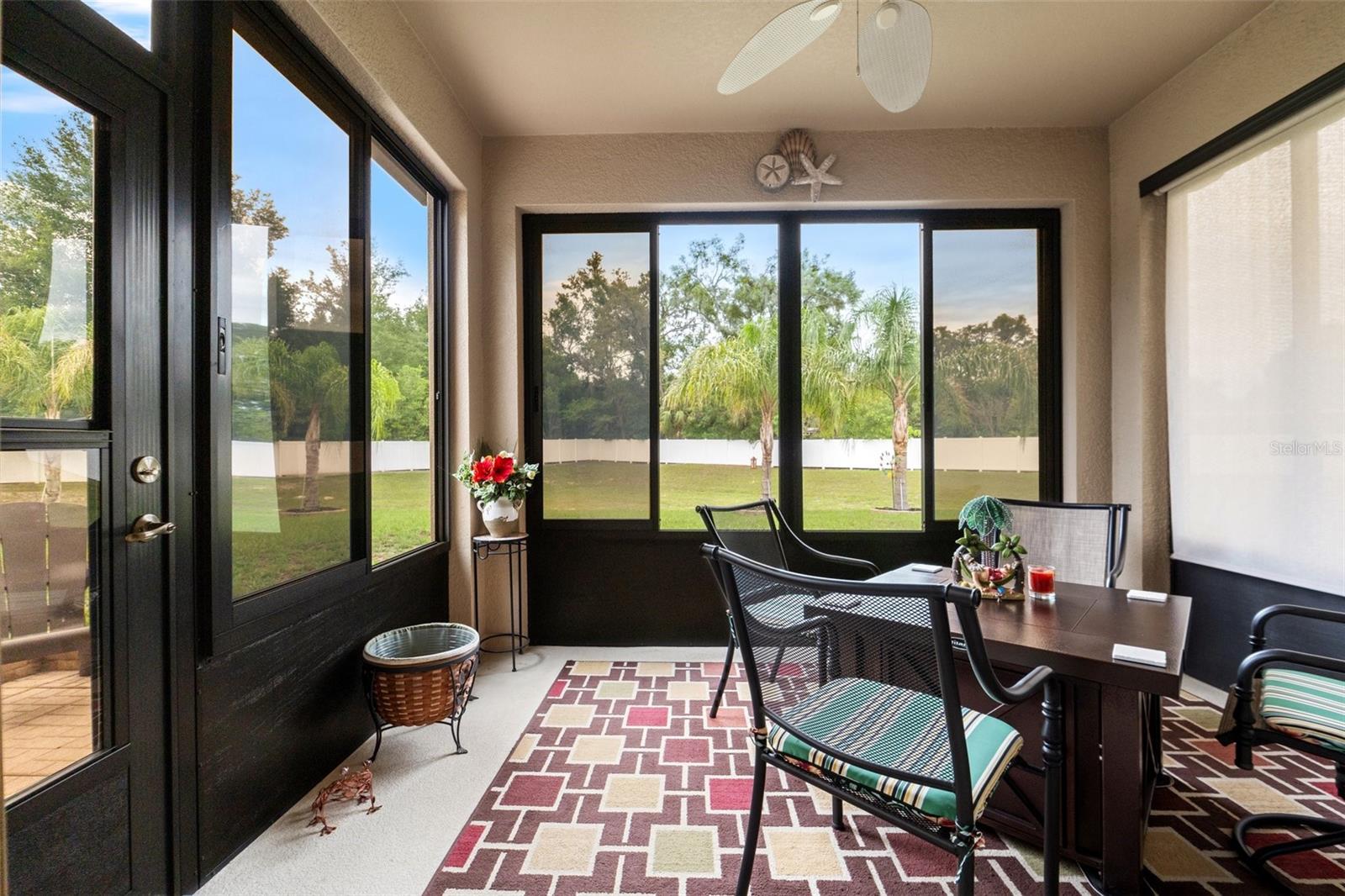 The Lanai with a slider from the kitchen, a door to the backyard and built with an expanded concrete pad & header, custom metal windows & screens, & custom roll away screen.