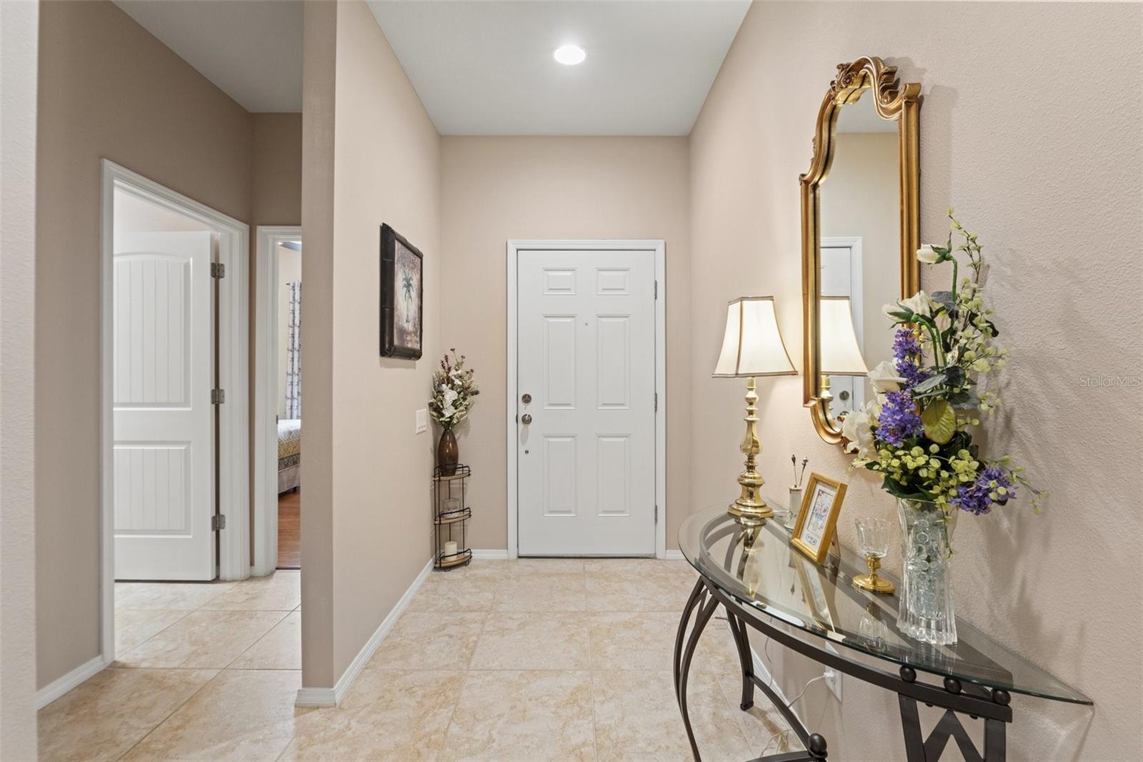 Looking back towards the front door with a nice wide hallway and the entrance to the mini-Secondary Bedroom wing.
