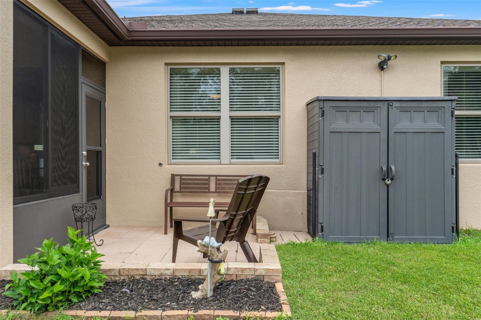 An outside patio space - perfect for grilling.  The Tool shed & the bench stay.