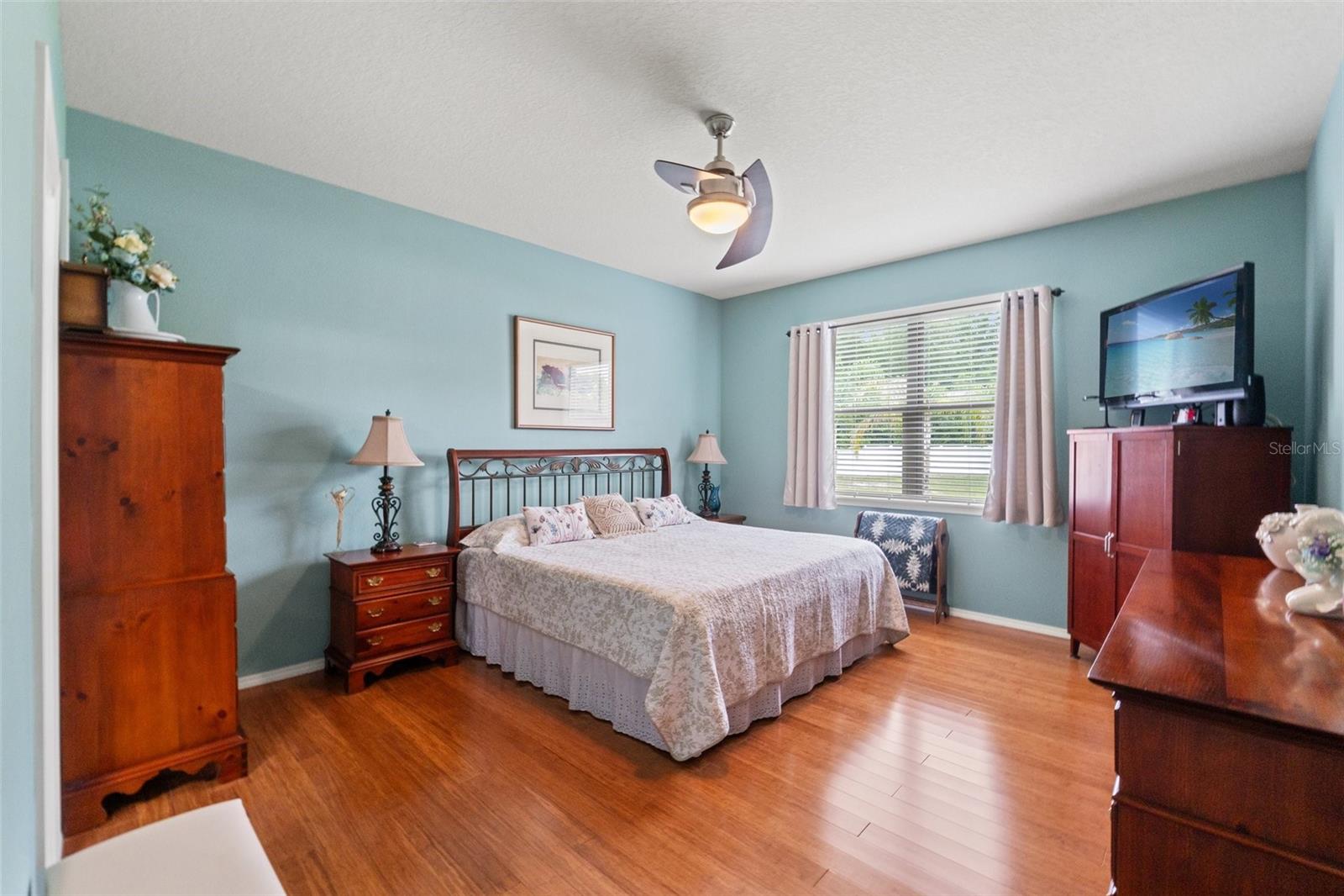 Pleasant, light & airy Master Bedroom with a view of the backyard.