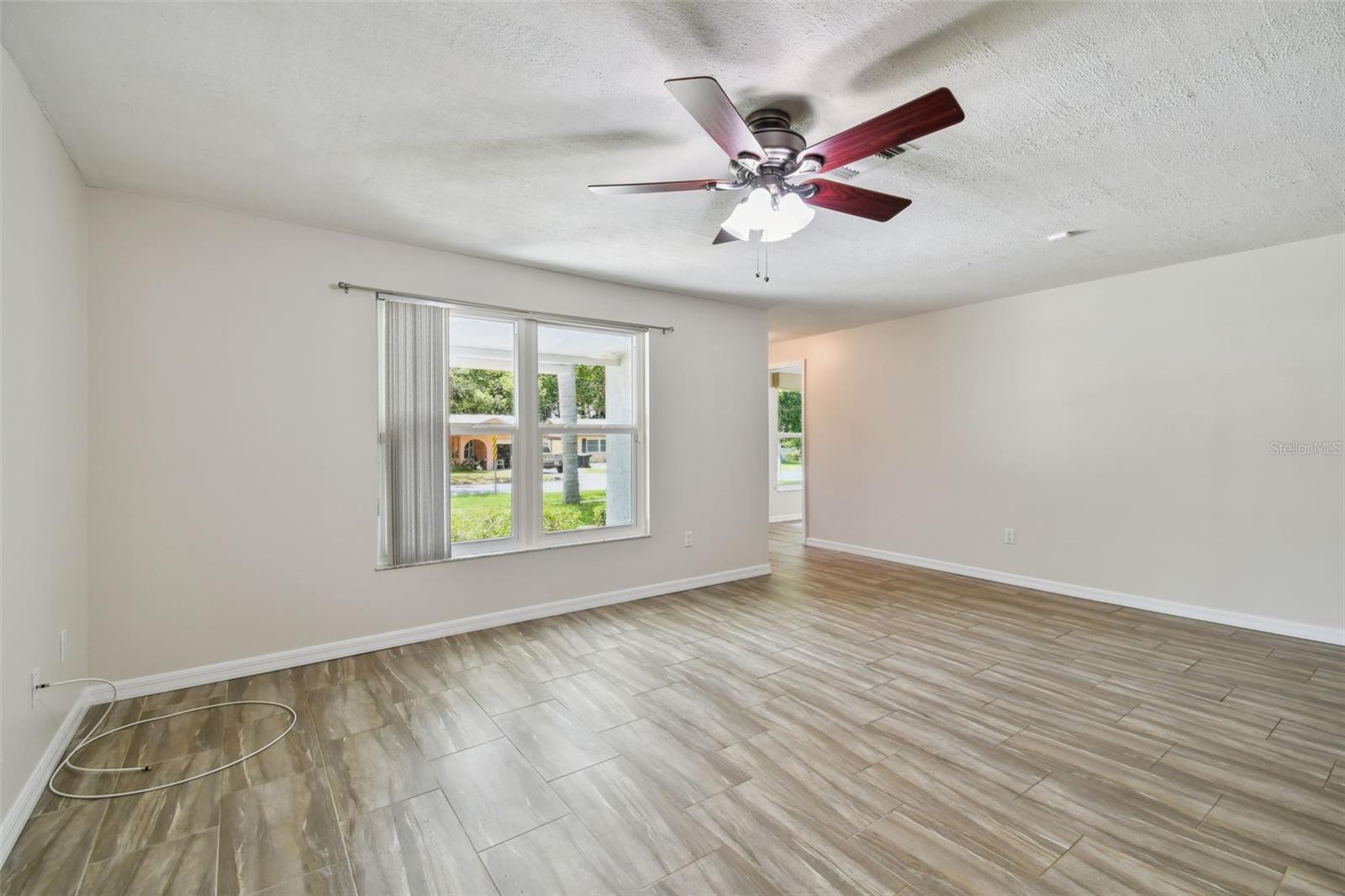 Wood-look ceramic tiling seamlessly throughout home.