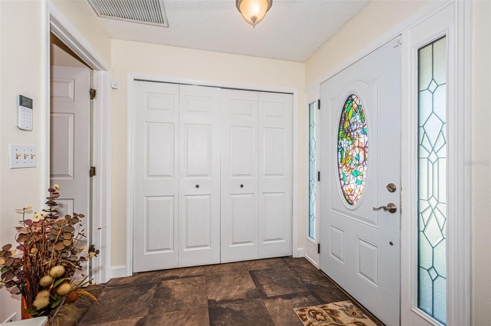 Foyer with large coat closet and storage