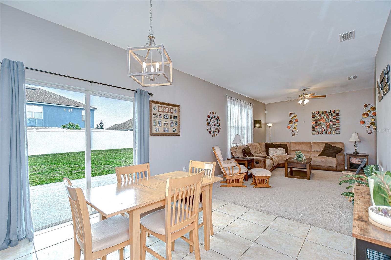 A cozy dining nook with sliding doors leads to the fully fenced backyard!
