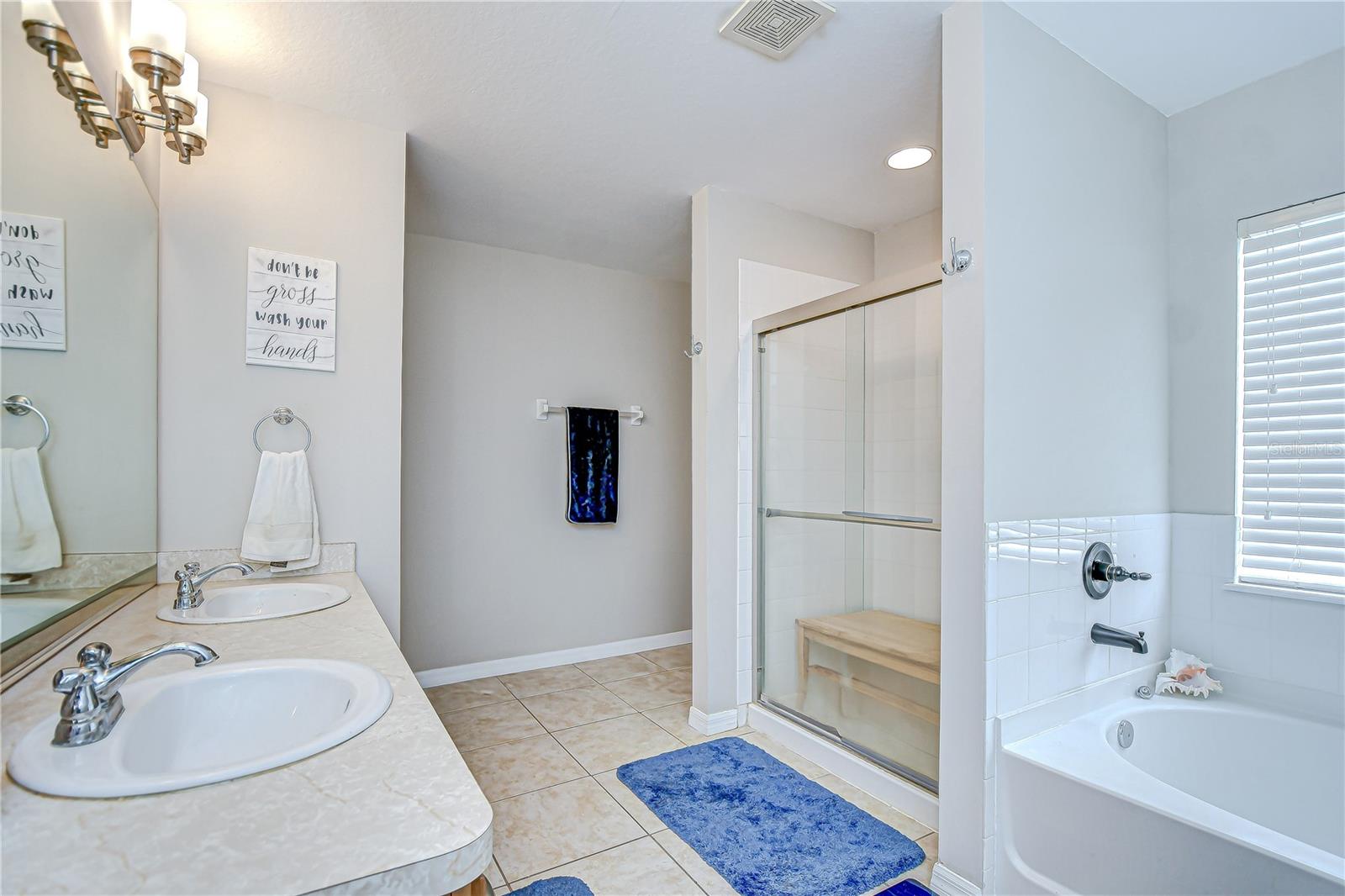 The en-suite bath features dual sinks, soaking tub, and separate shower!