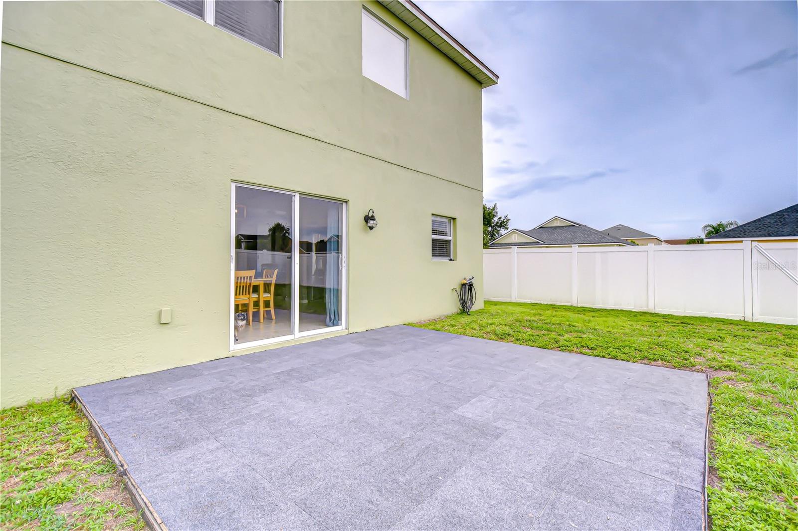 The fenced backyard is perfect for pets, parties, or peaceful evenings.