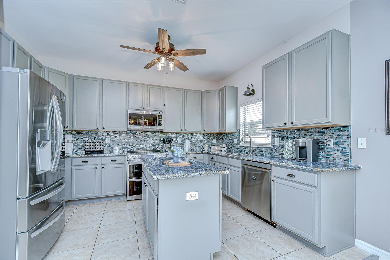 The kitchen has been tastefully updated with granite countertops (2021), new backsplash (2025), and a full suite of stainless steel appliances!