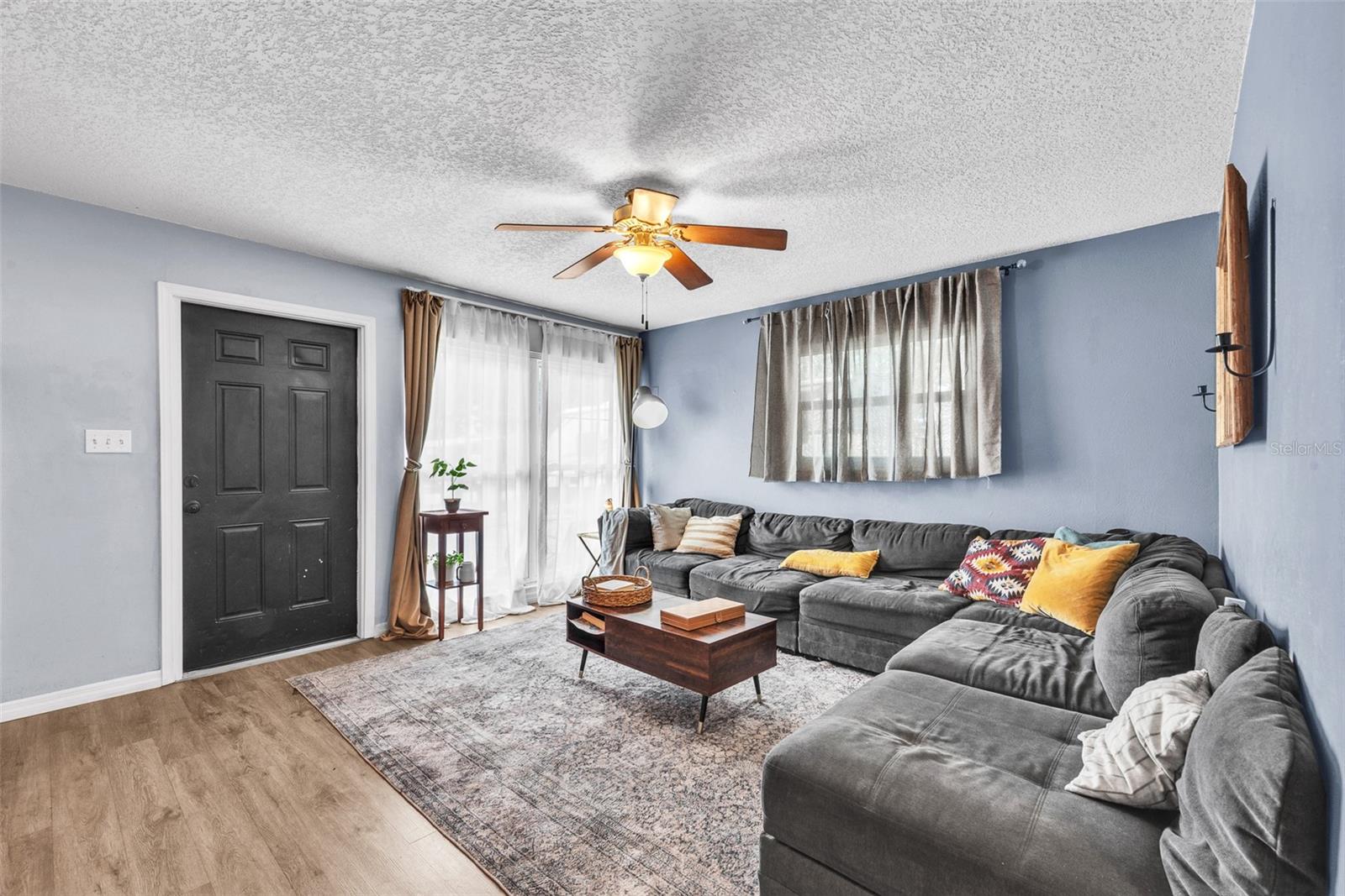 Step inside to a 15' x 13' Living room with fan and durable Luxury Vinyl Flooring.