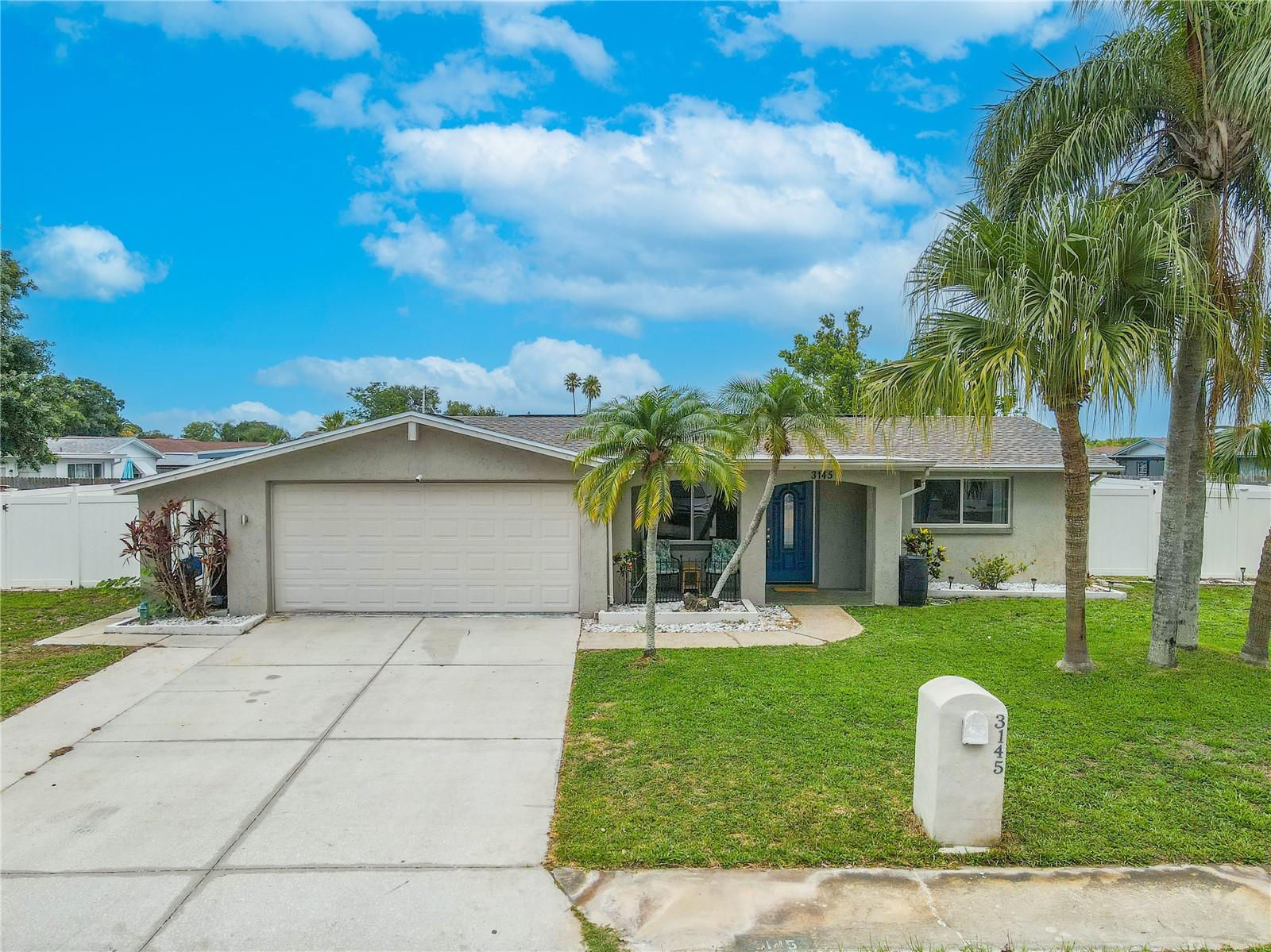 Charming and well-maintained 2-bedroom, 2-bath home with bonus room and a spacious 2-car garage, with inviting curb appeal, tropical landscaping, located in established Holiday Lakes Estates neighborhood.