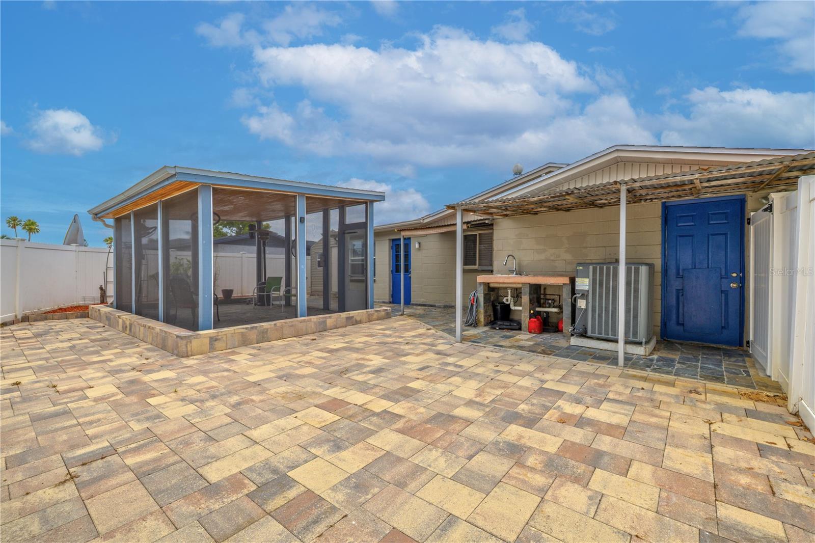 Your private outdoor escape—an expansive screened-in retreat designed for year-round enjoyment