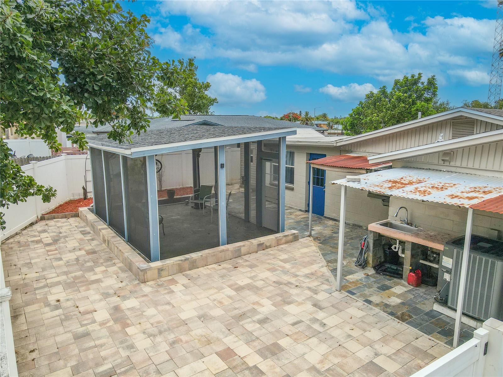 Screened room - Set on a paver patio and framed by privacy fencing