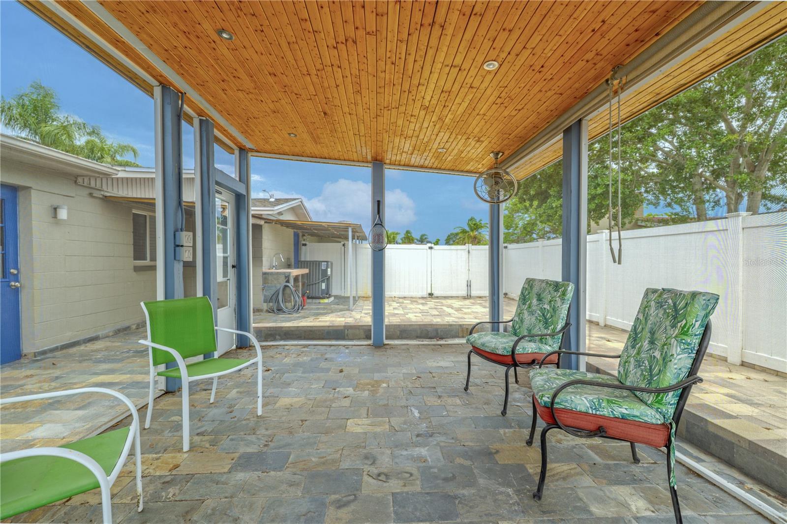 This freestanding structure features high ceilings finished in warm wood planks, built-in lighting, and dual ceiling fans for comfort on even the warmest days.