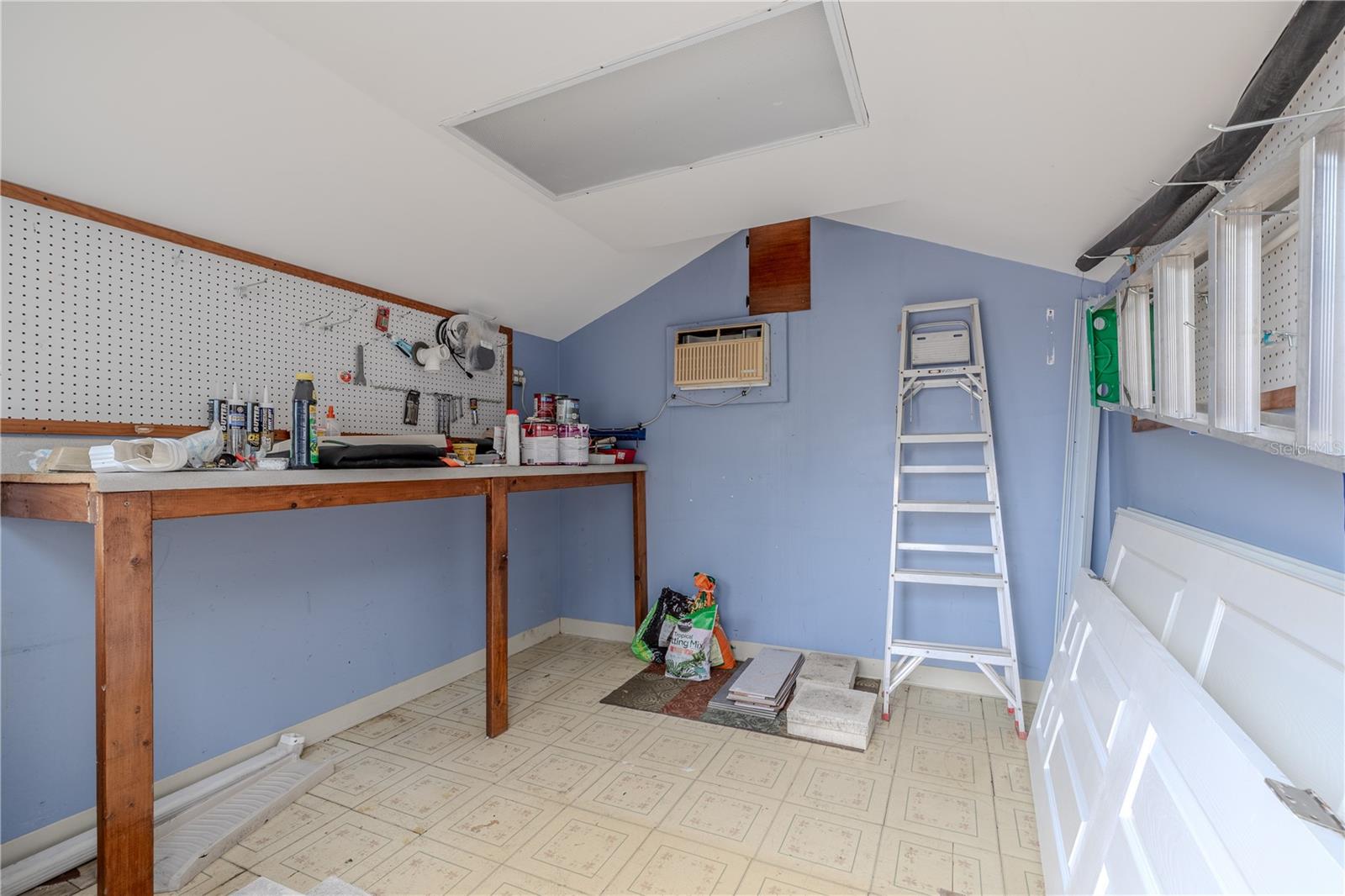 Inside the stroage shed, you’ll find a built-in workbench, pegboard wall for easy tool organization, and ample room for shelving or hobby supplies. Whether you're into gardening, crafting, or simply need extra storage beyond the garage, this detached workspace is a practical and private extension of the home.