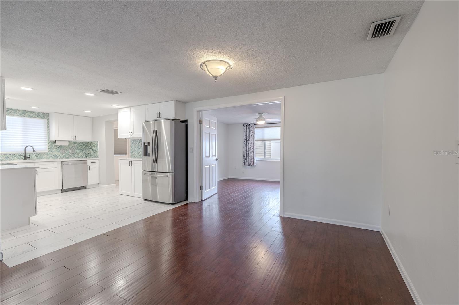 This open-concept living space flows effortlessly into the kitchen and adjacent rooms, enhancing both functionality and connectivity.