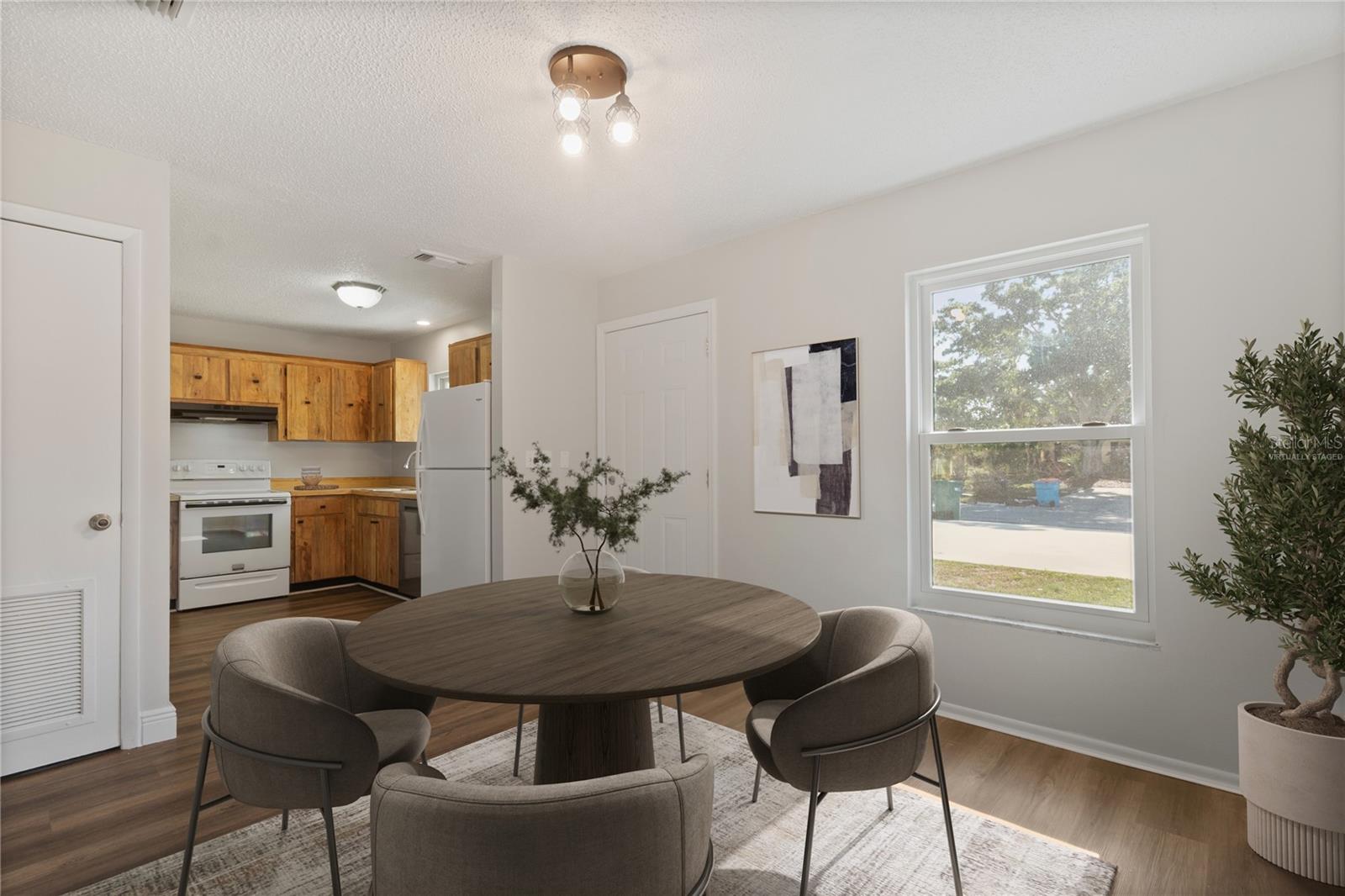 Virtually staged dining area/ kitchen