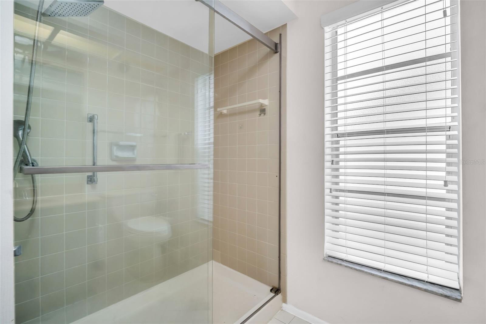 En-suite updated with glass enclosure & rain showerhead~