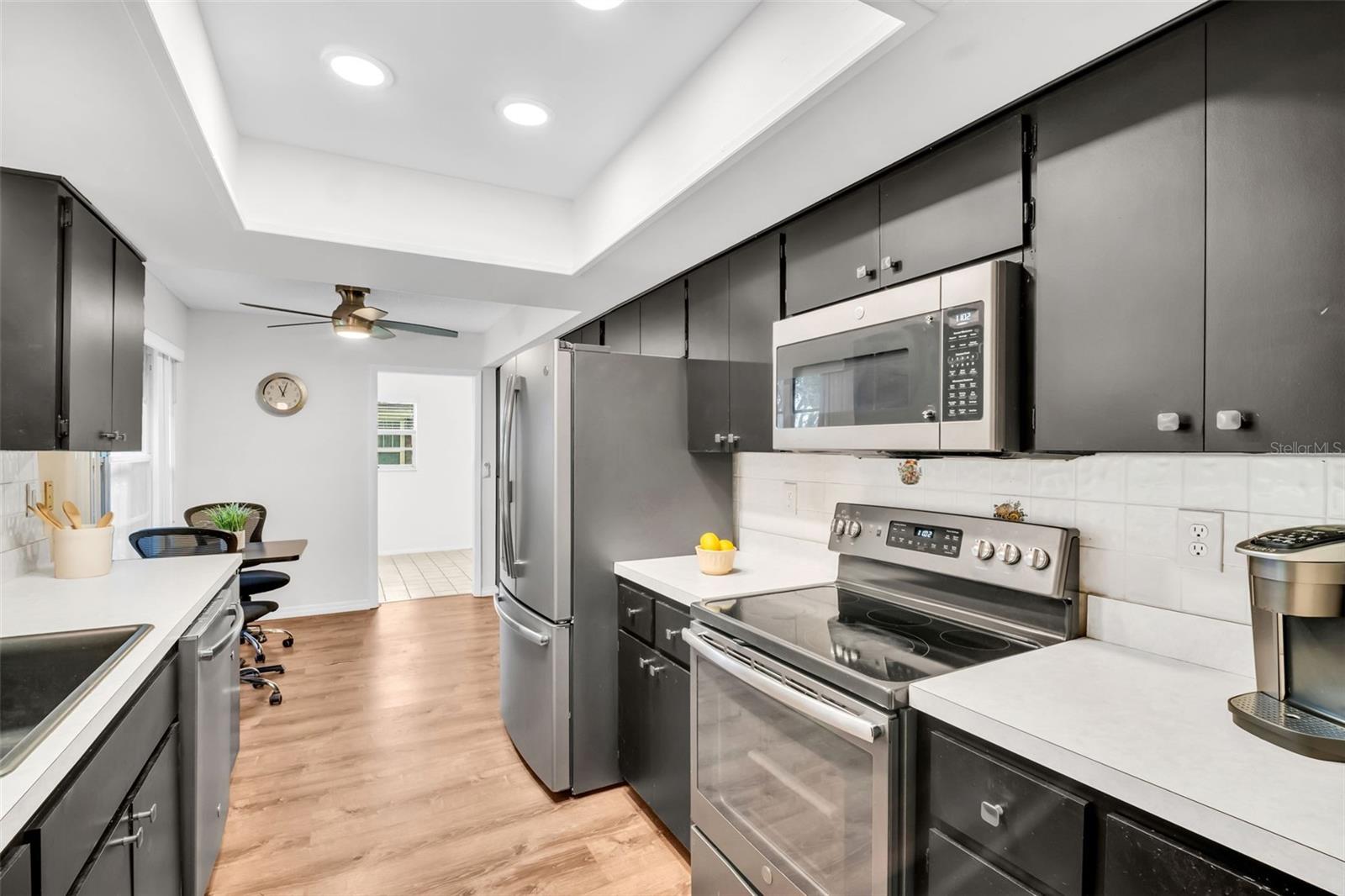 Spacious eat-in-kitchen with newer stainless appliances, abundant cabinets, & recessed lighting~