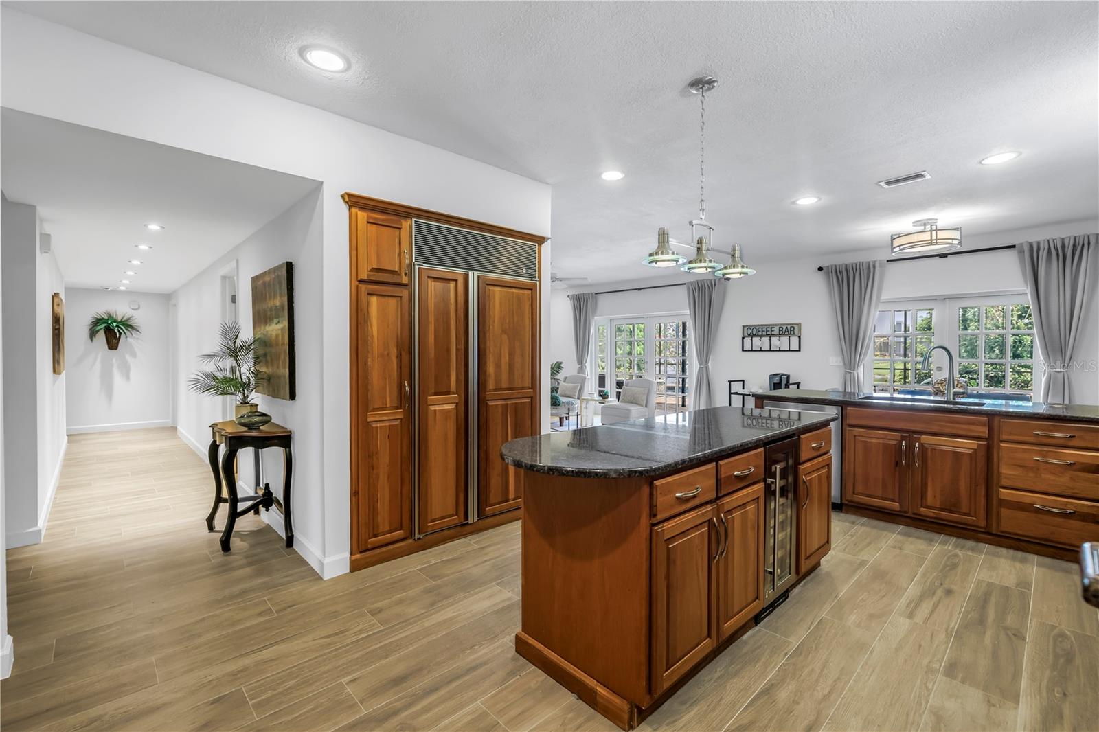 Open Kitchen with a complete custom cabinetry installation, granite, and excellent appliances