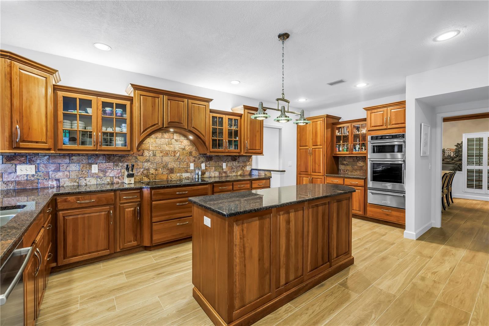 Kitchen Island with power outlets, Cooktop with downdraft exhaust.