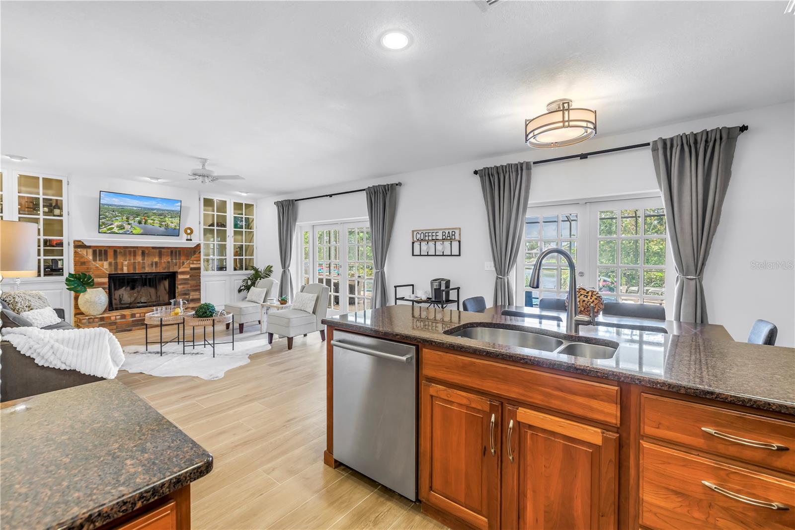Kitchen space is open to living and breakfast area, while beautiful views of the lake and pool area present