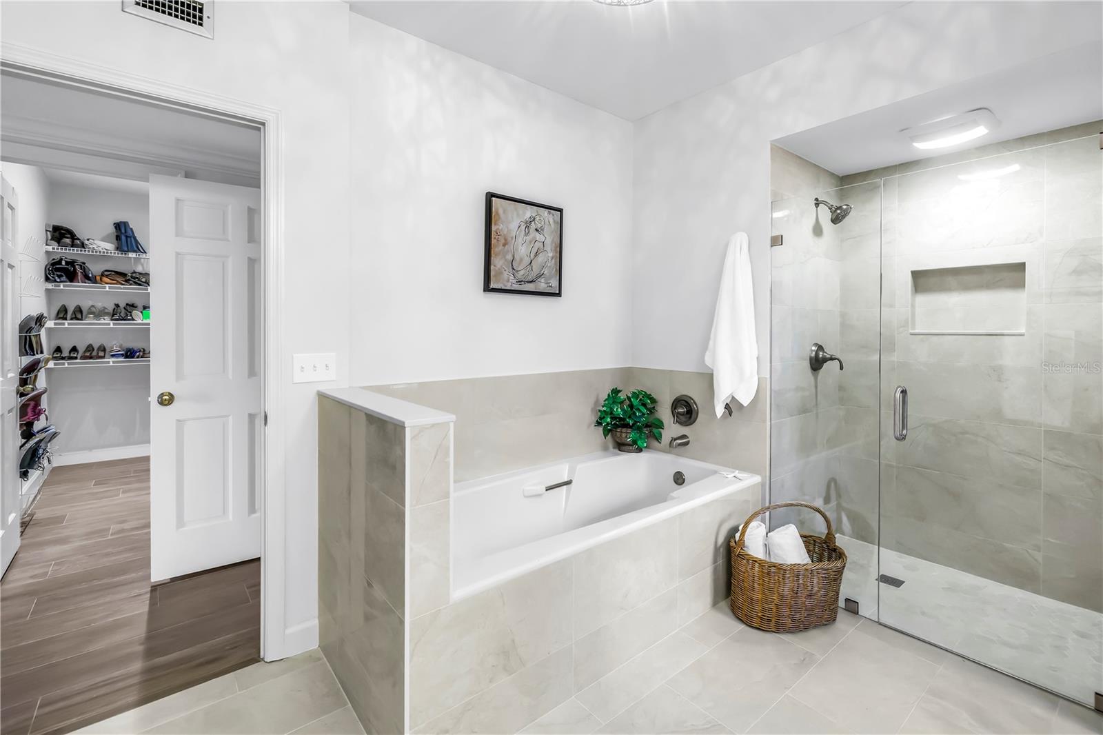 Tub Surround retiled to match floor and newly updated shower