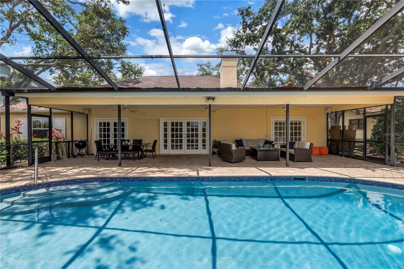 Expansive covered outdoor living space and dining space is key to summer living