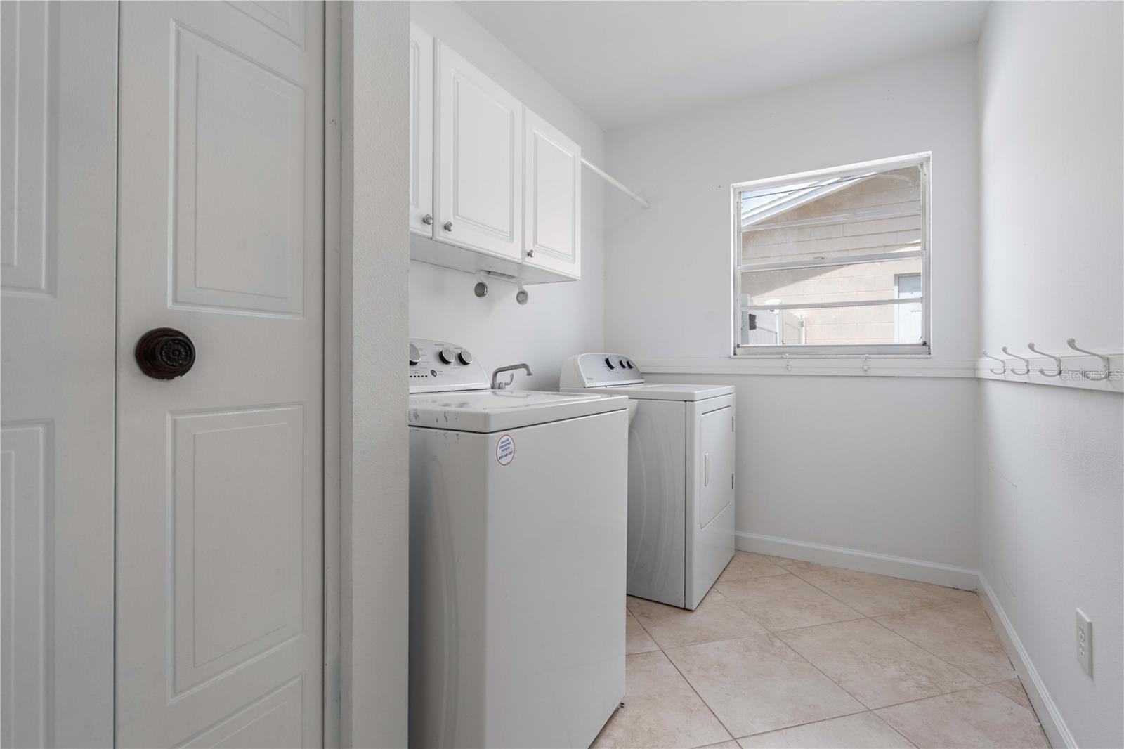 INDOOR LAUNDRY ROOM w/ closet and soaking tub