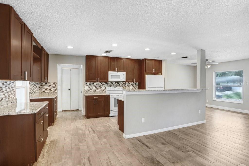 Kitchen with beautiful 42 inch cabinets, granite countertops and beautiful backsplash