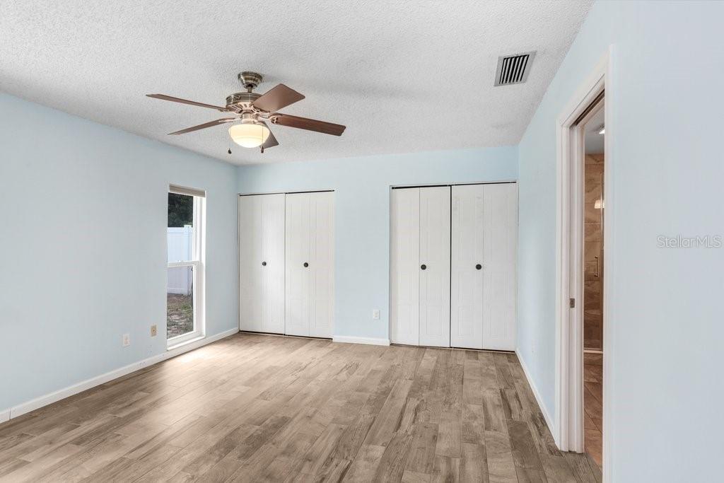 Primary bedroom with beautiful tile and updated bathroom