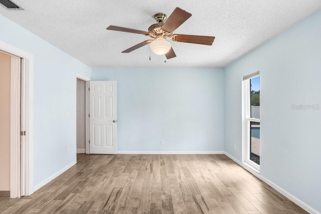 Primary bedroom with beautiful tile and updated bathroom