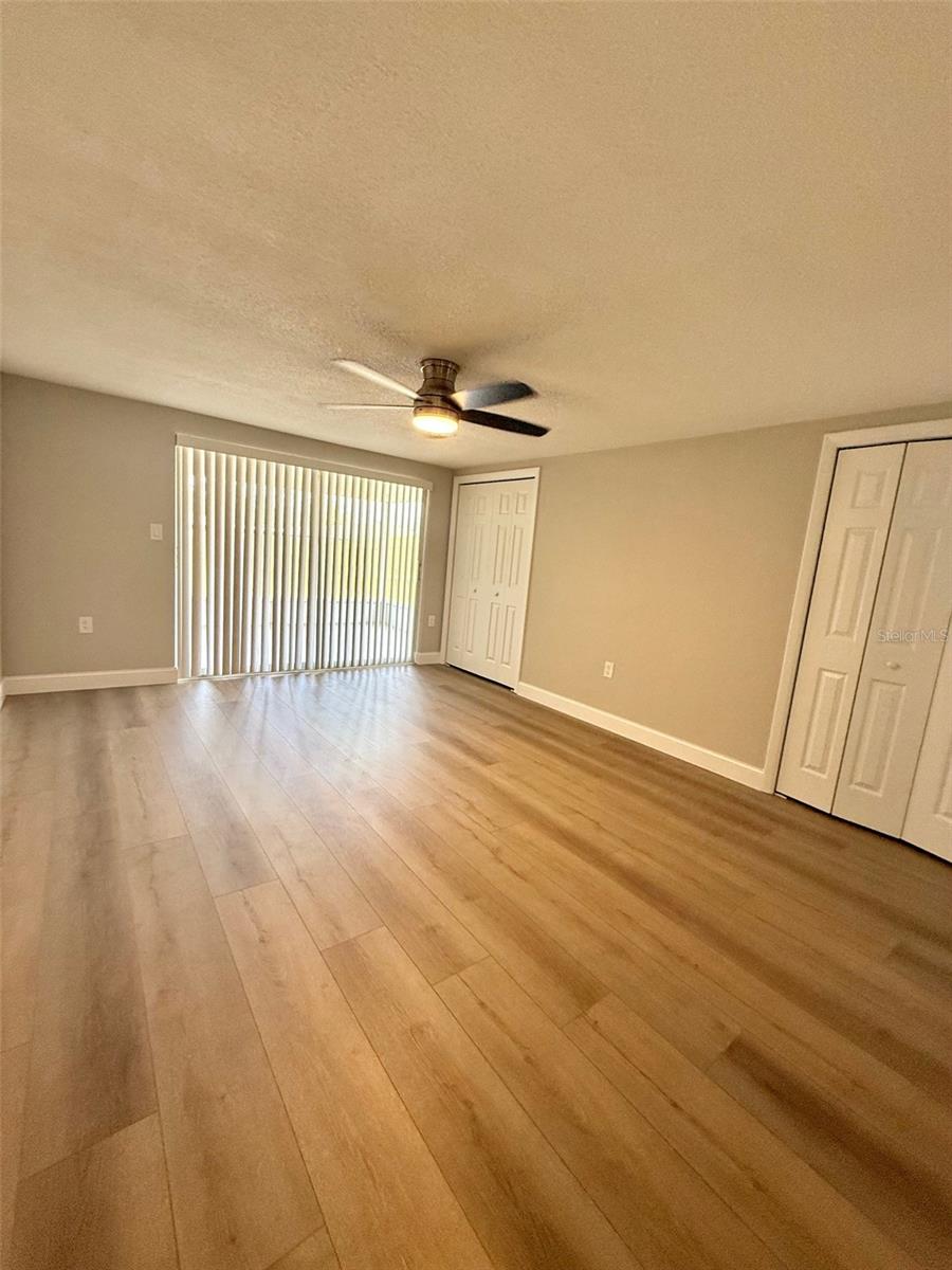 Primary Bedroom with Sliding Door Access to Screened Patio