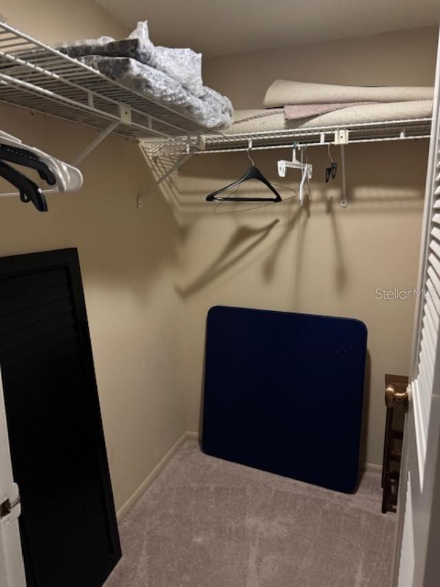 2 of 3 closets in primary bedroom