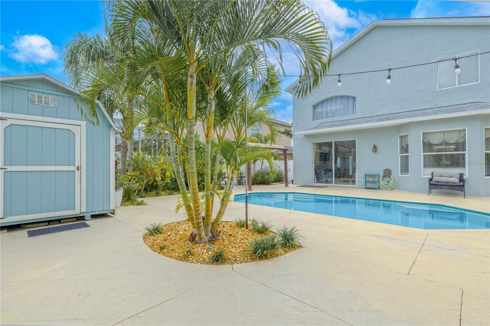 A charming storage shed offers additional functionality, while the layout of the yard is thoughtfully designed for privacy, comfort, and effortless outdoor living.