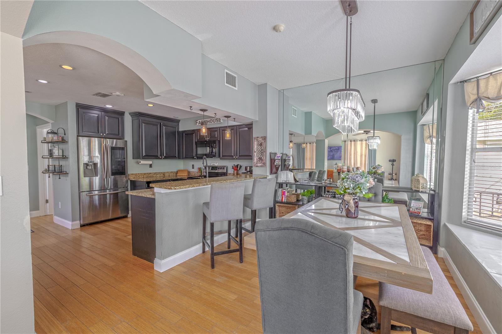 The open layout maintains clear sightlines into the kitchen and living areas, making this space perfect for both casual meals and elegant entertaining. With its thoughtful layout and timeless features, this dining area is both stylish and functional.