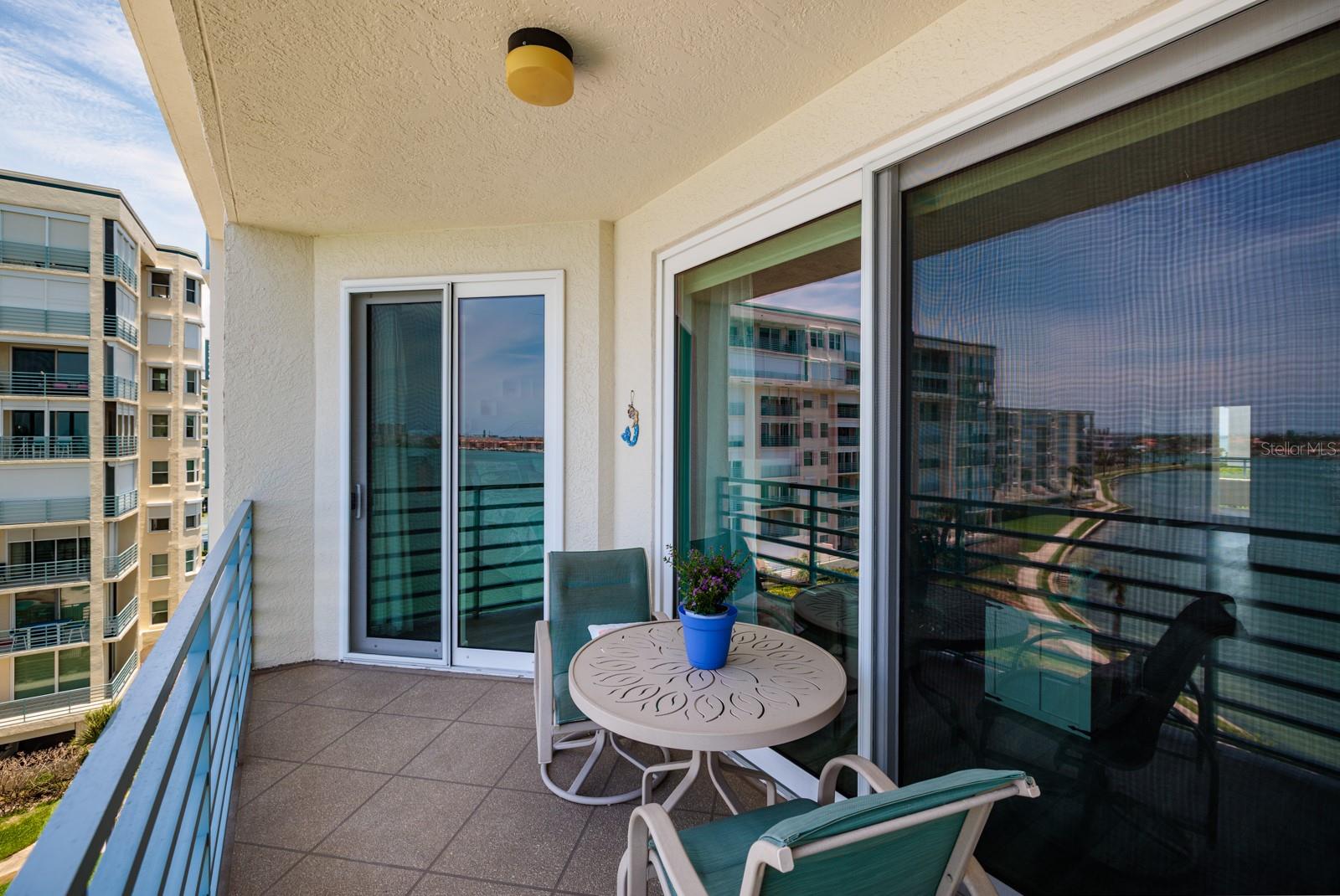 Balcony with sliders to living area and primary bedroom