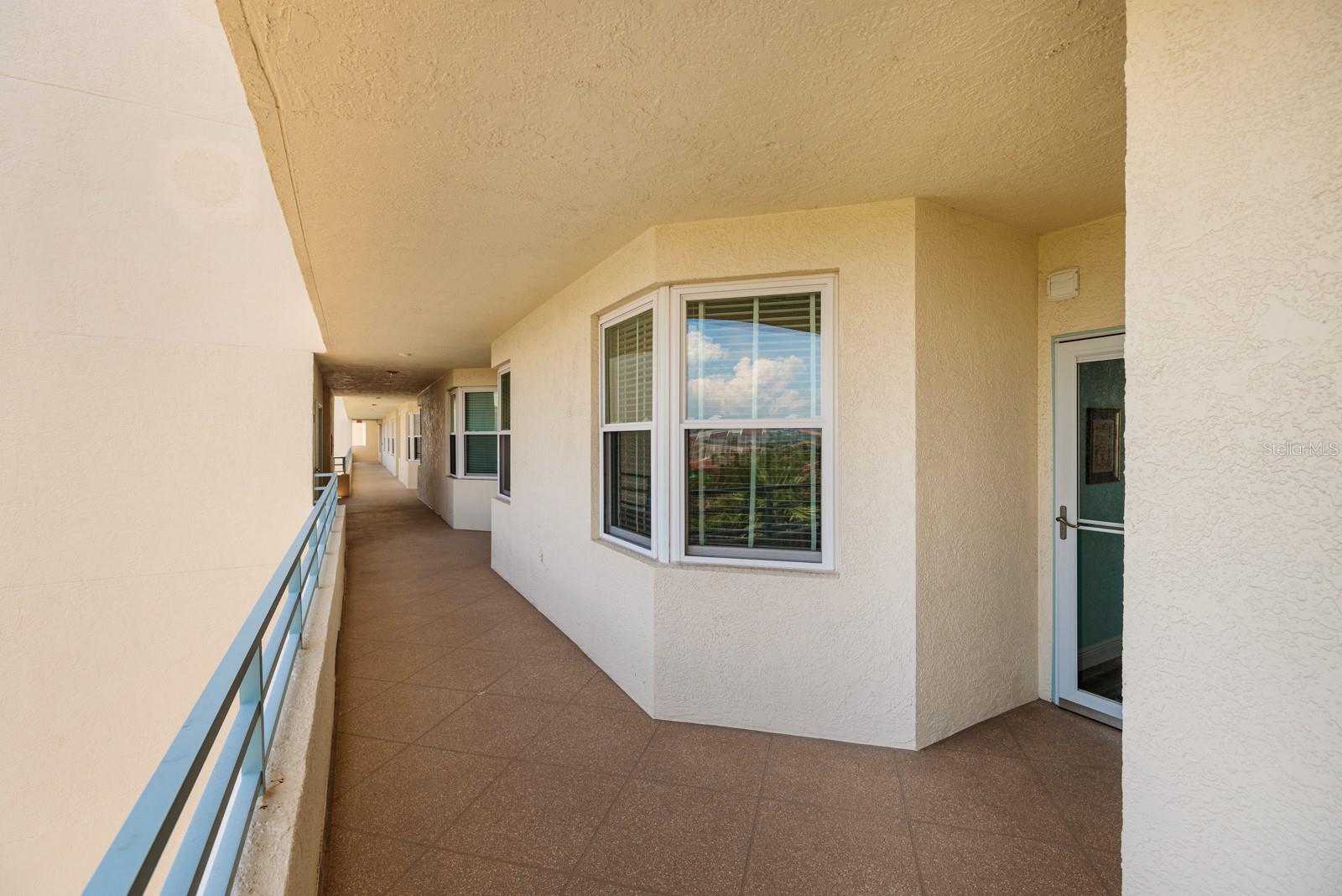 Outdoor hallway is open air.