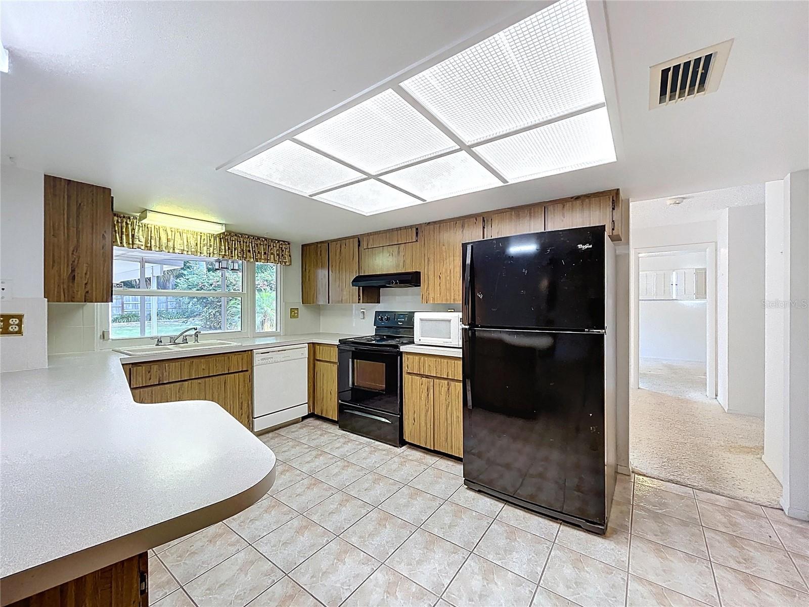 Kitchen offers a closet pantry and plenty of cabinet space.