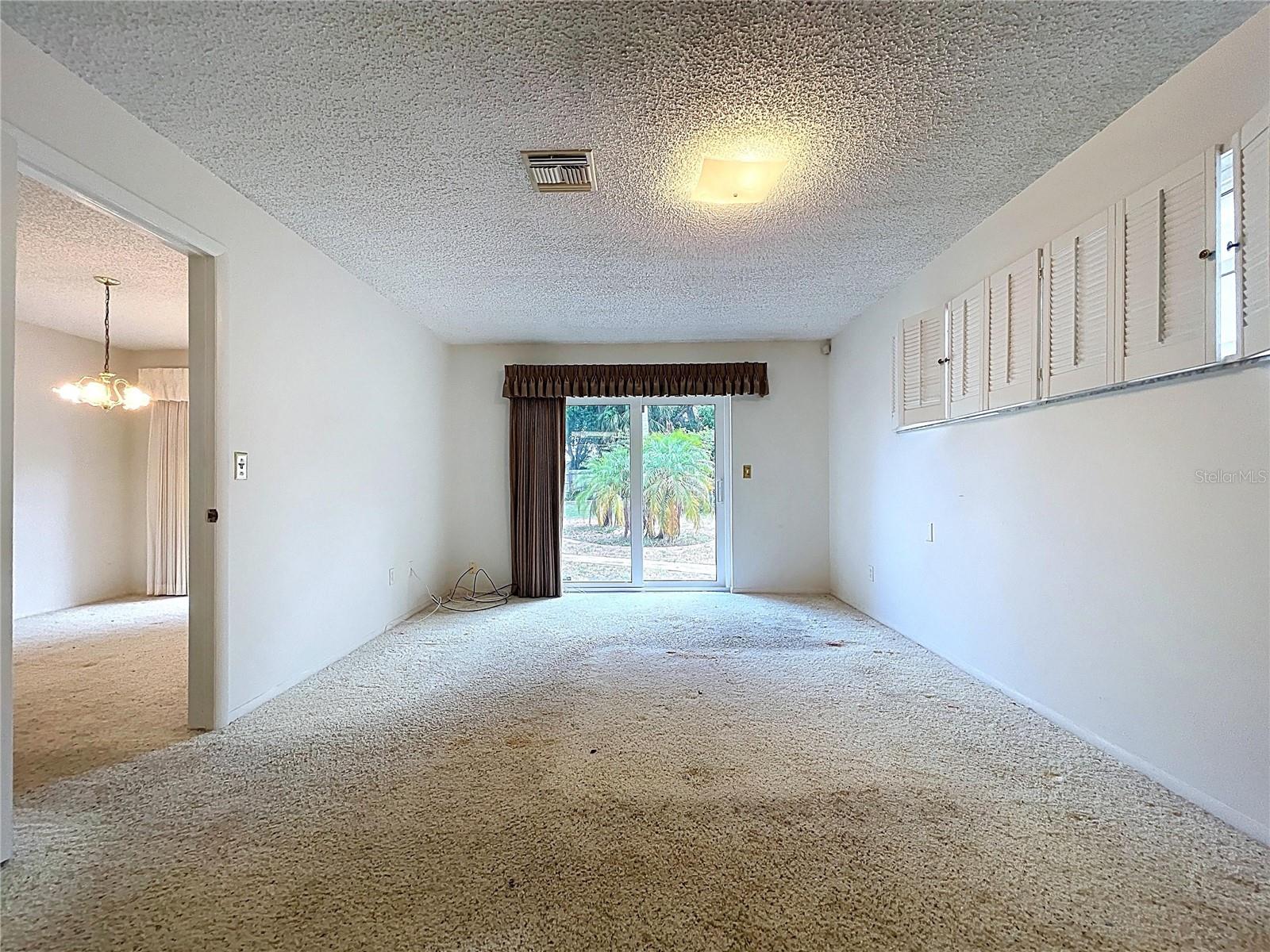 Ample natural light through double pane windows and sliding glass door.
