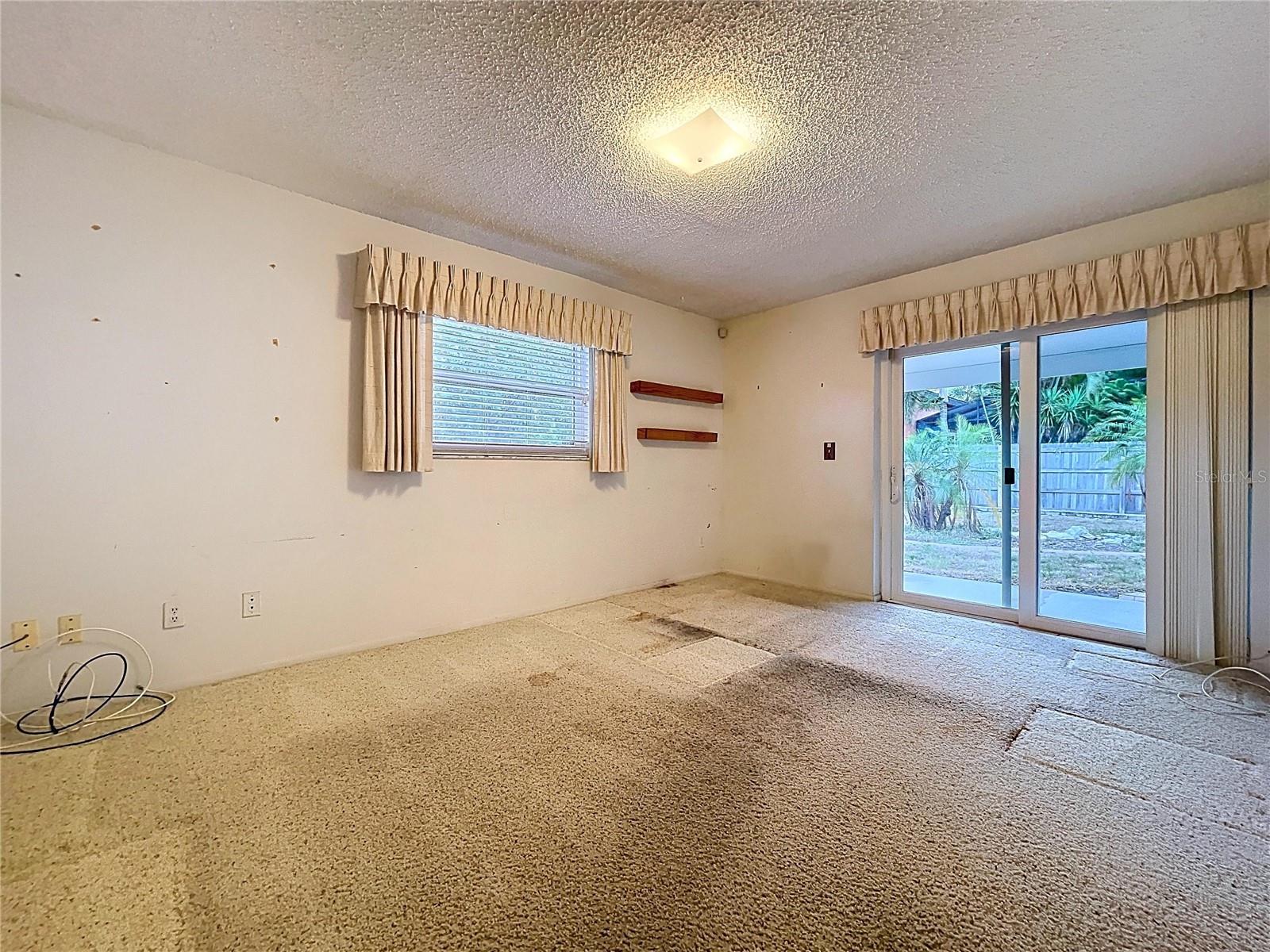 2nd bedroom with double pane windows and sliding glass door onto rear patio.