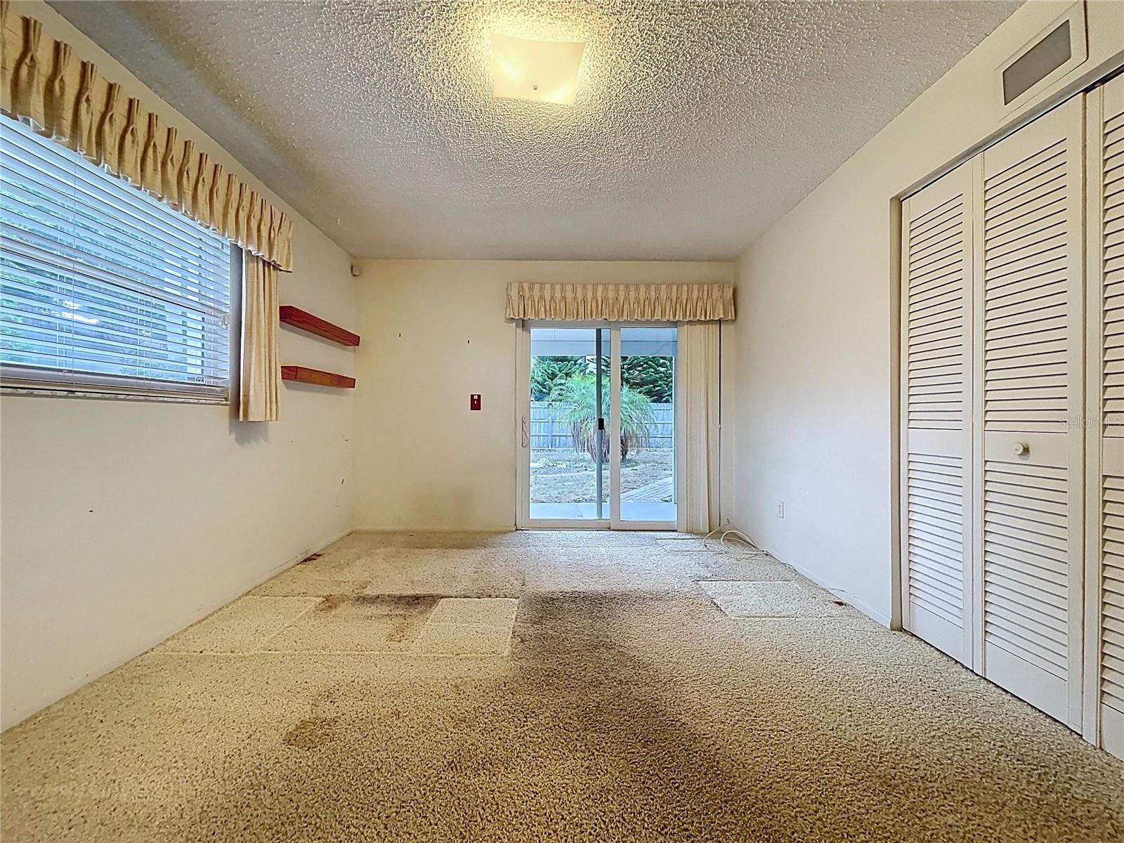 2nd bedroom with double pane windows and sliding glass door onto rear patio.