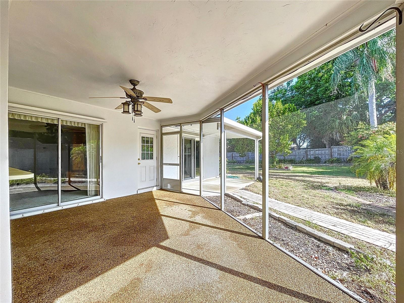 Screened patio offers a covered space to entertain and soak in the Florida weather.