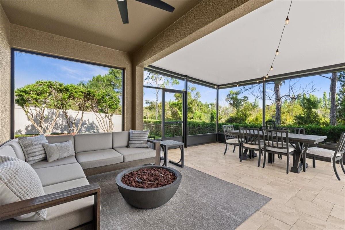 Oversized back patio with seating and dining areas