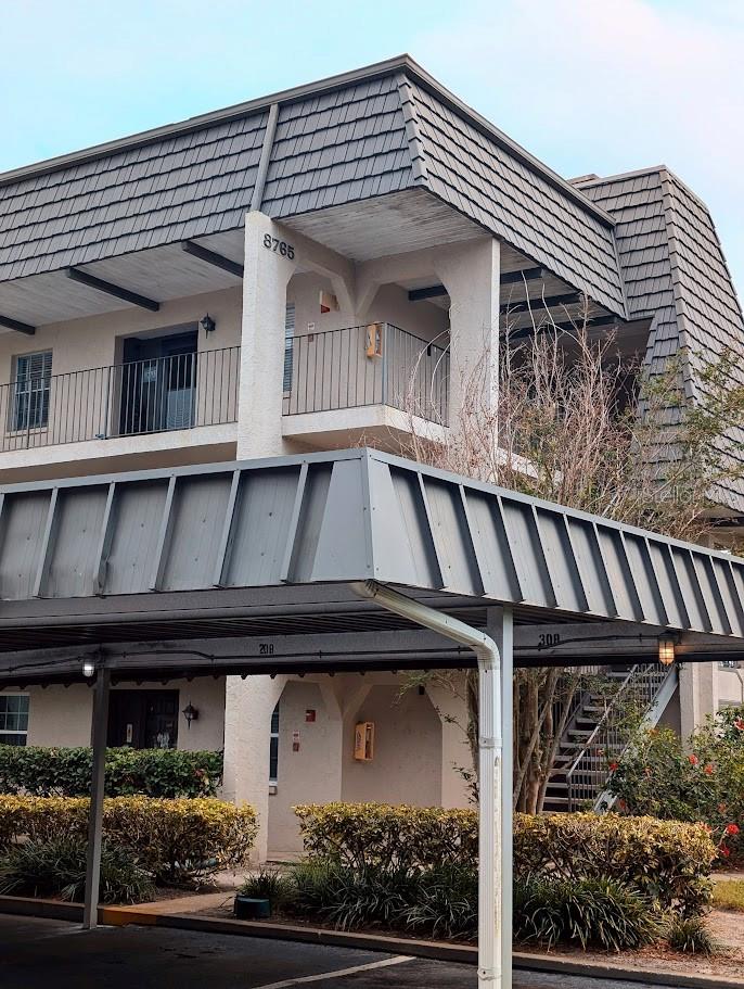 Corner unit exterior with view of covered parking