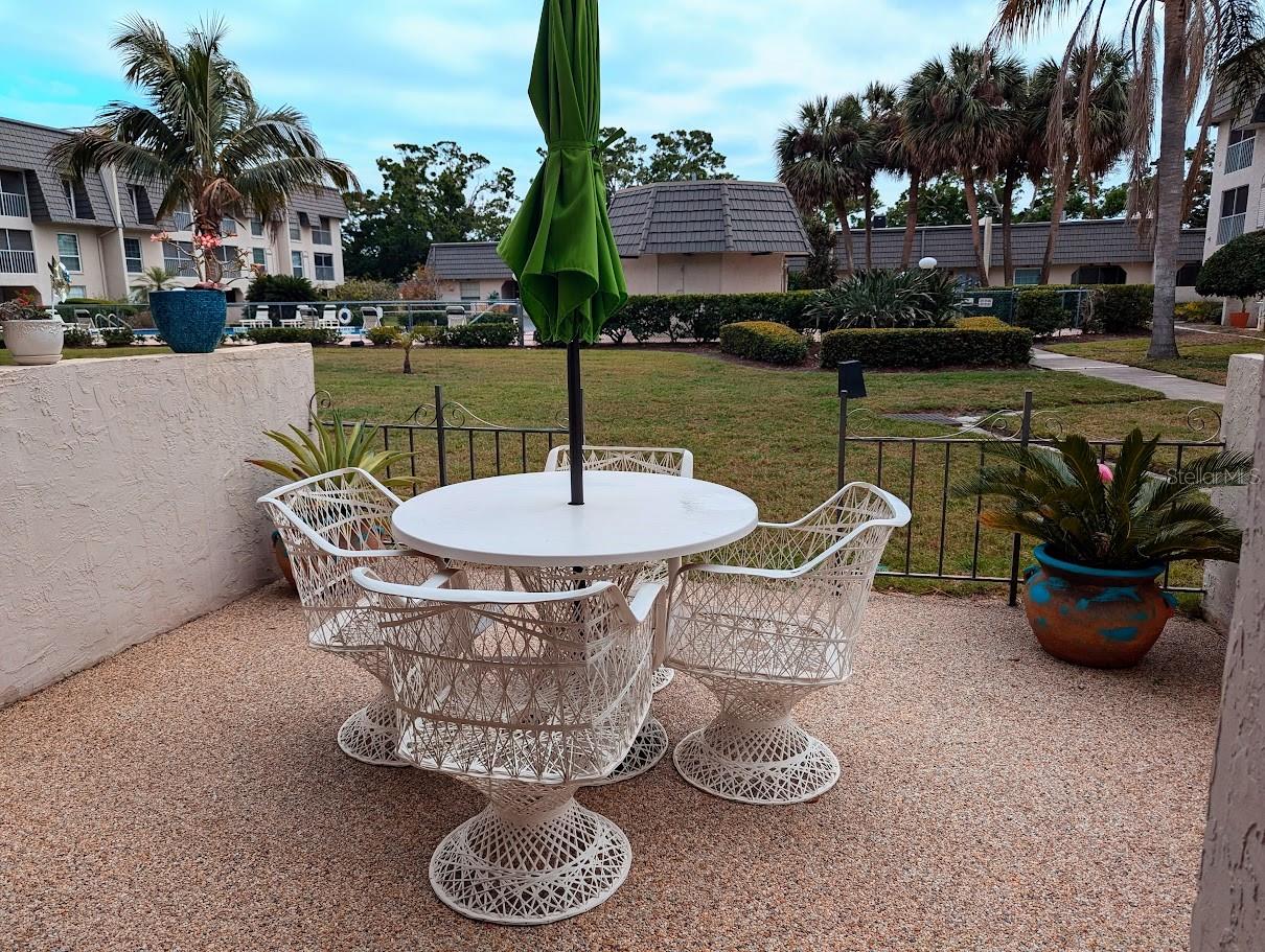 Corner unit patio with view to community pool and spa area