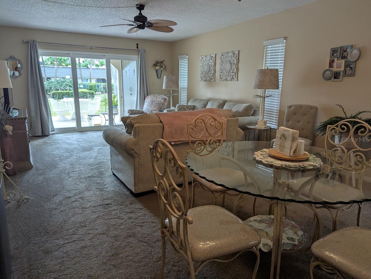 Living and dining space with access to patio